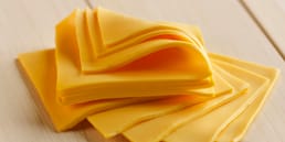 American Cheese is a Combination of Cheddar, Colby, Washed Curd, or Granular Cheeses. According to Federal Law, This Product Must be Labeled as “Processed American Cheese.”