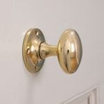 Brass doorknobs (or any other brass objects) sterilise themselves after about 8h since bacteria have a hard time surviving on brass. This is called the Oligodynamic Effect.